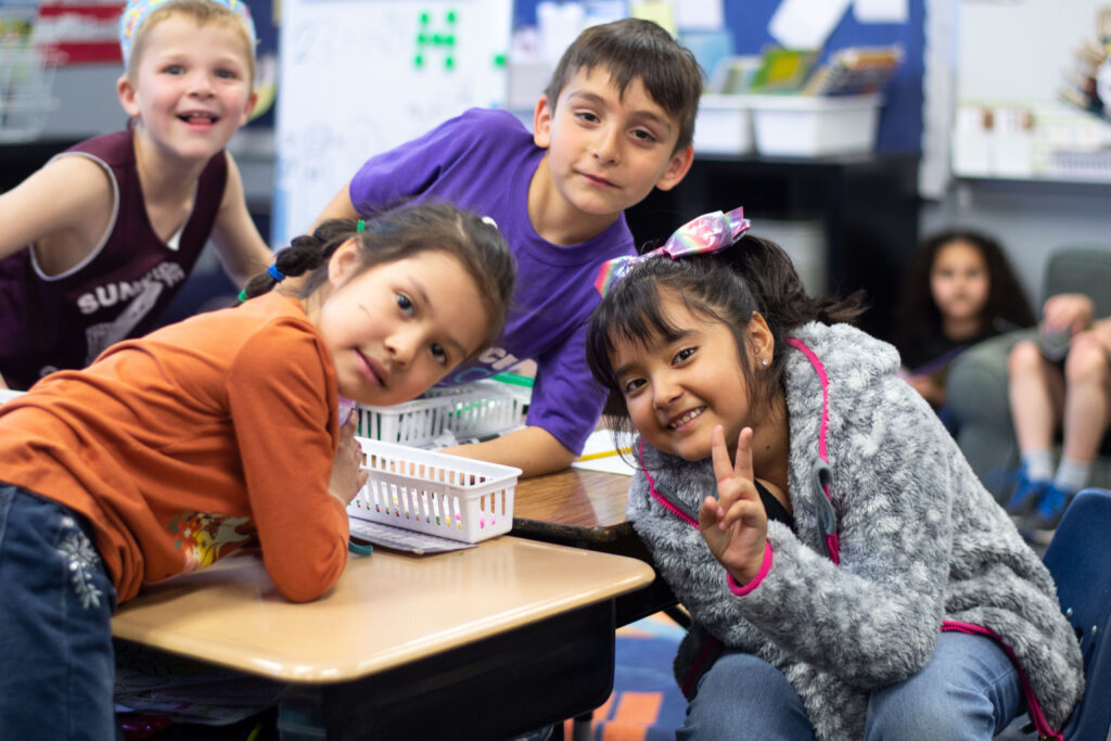 elementary students smiling in a group