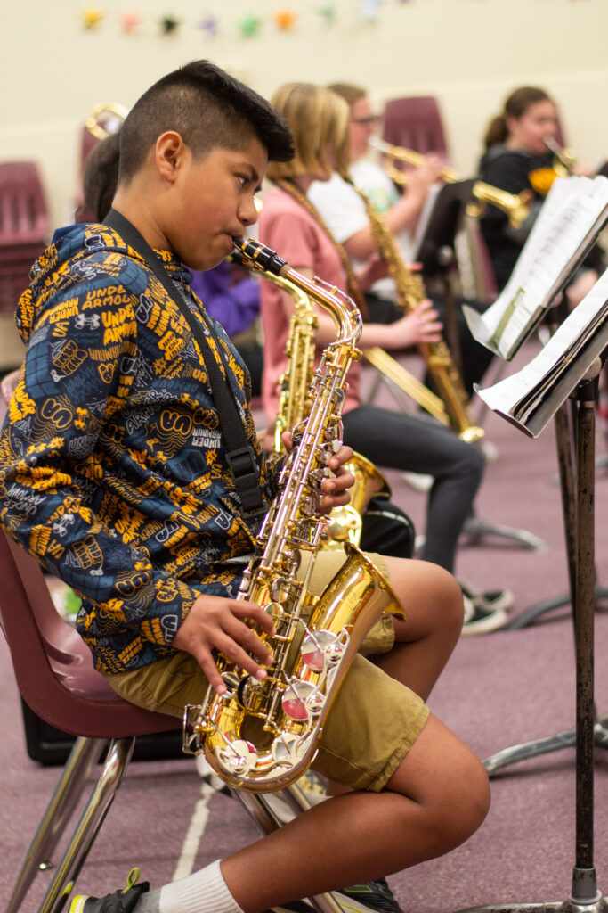 boy playing a saxophone